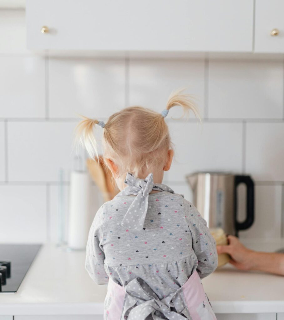 A little girl playing in the kitchen