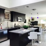 A contemporary kitchen with dark cabinets