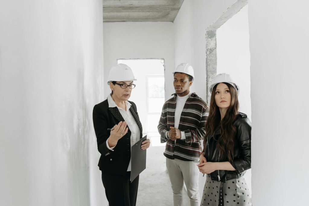 Architect consulting couple in an unfinished room