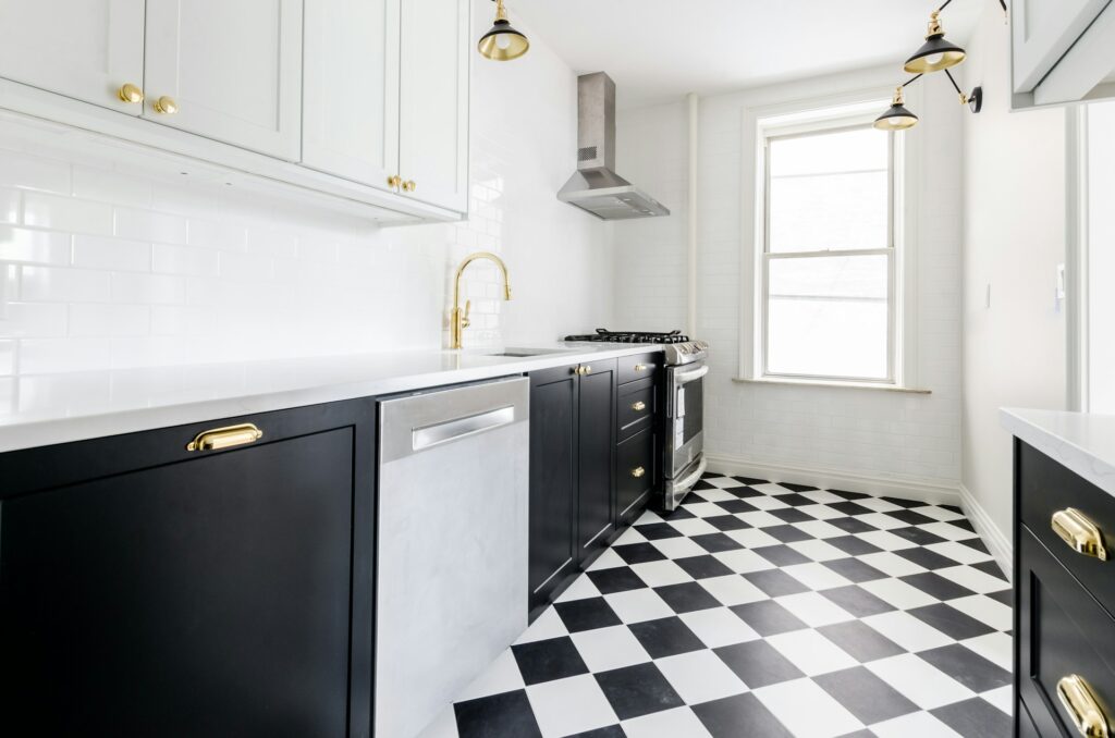 Unoccupied kitchen with checkerboard tile flooring