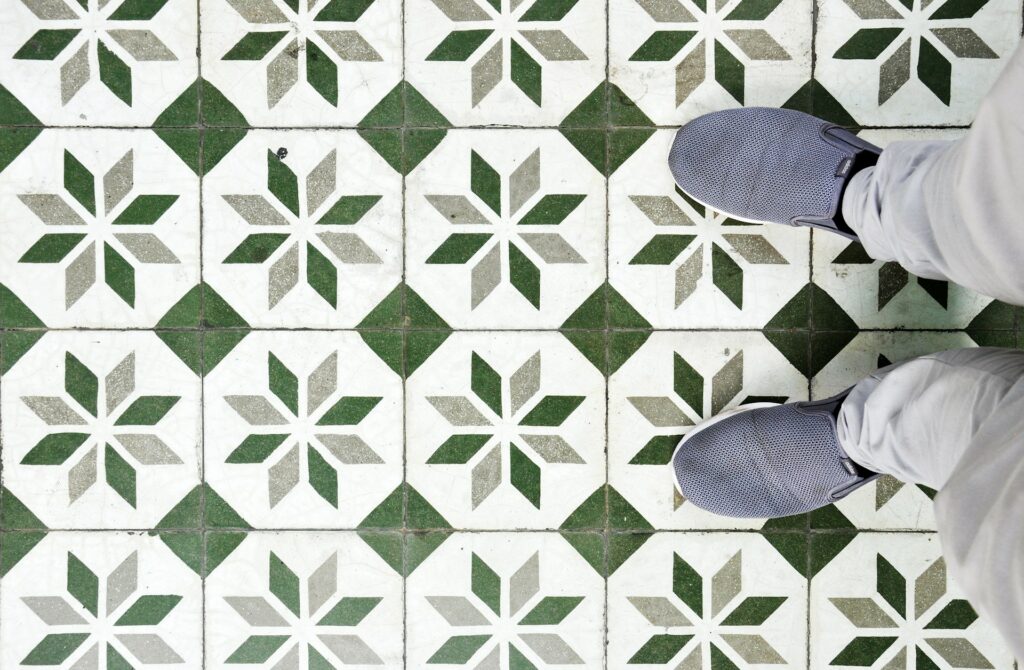 Person standing on tile with geometric pattern